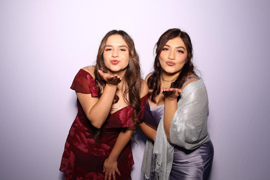 Guests posing in front of the lavender backdrop